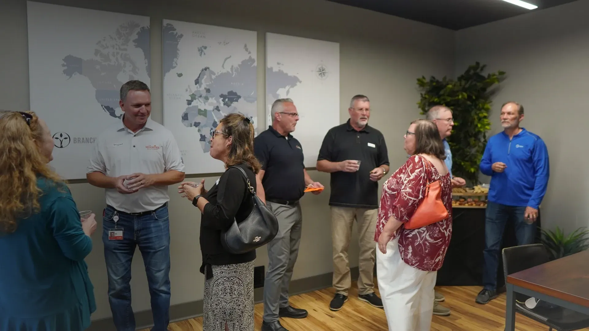 group of people talking in front of map