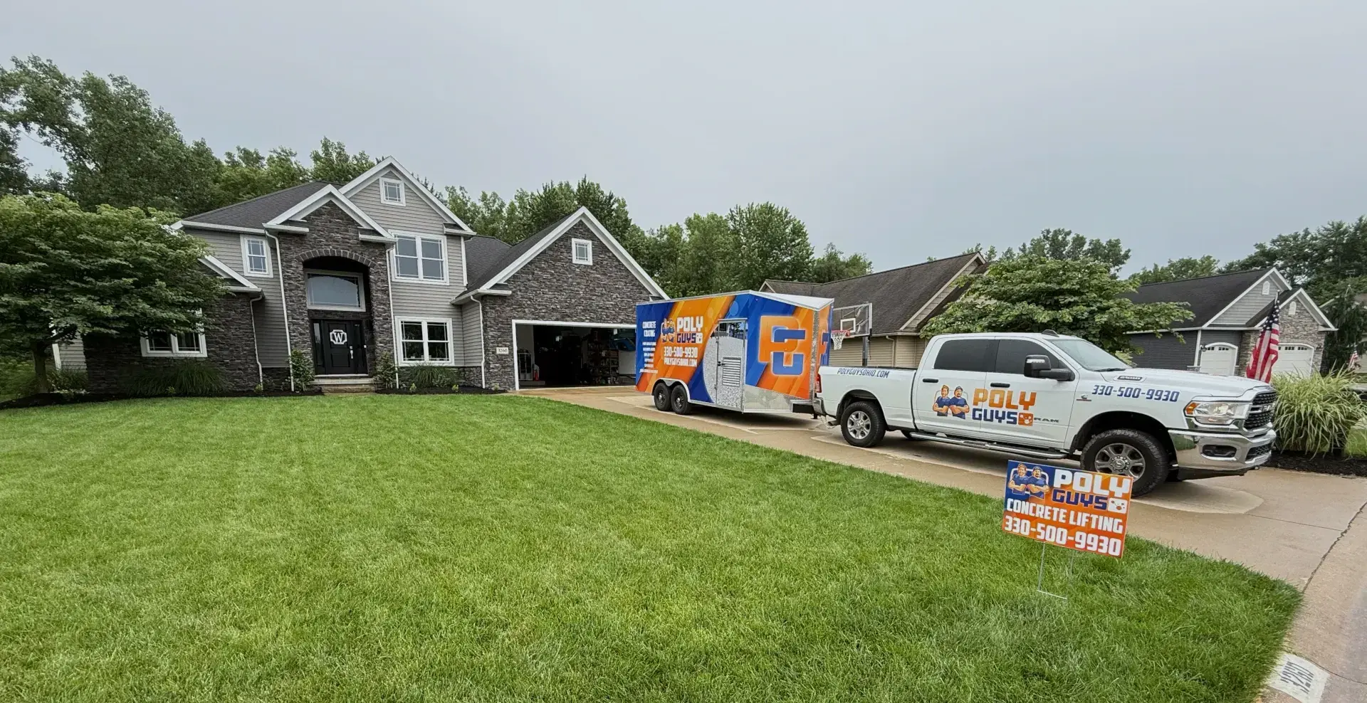 poly guys truck and trailer in residential driveway
