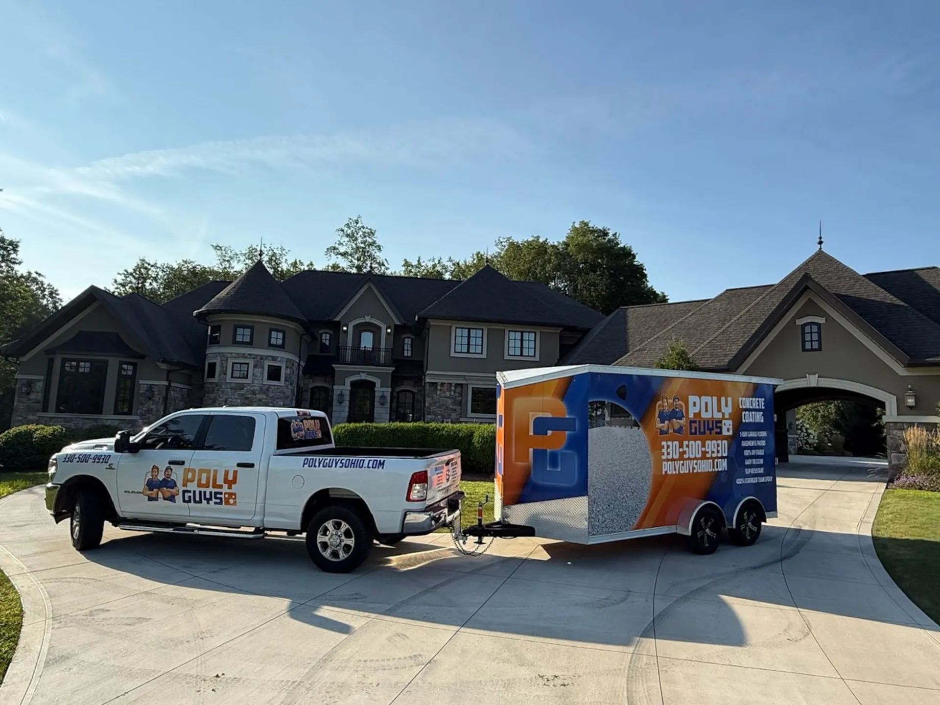 white pickup truck with poly guys logo, pulling a blue and orange poly guys trailer in front of a large house