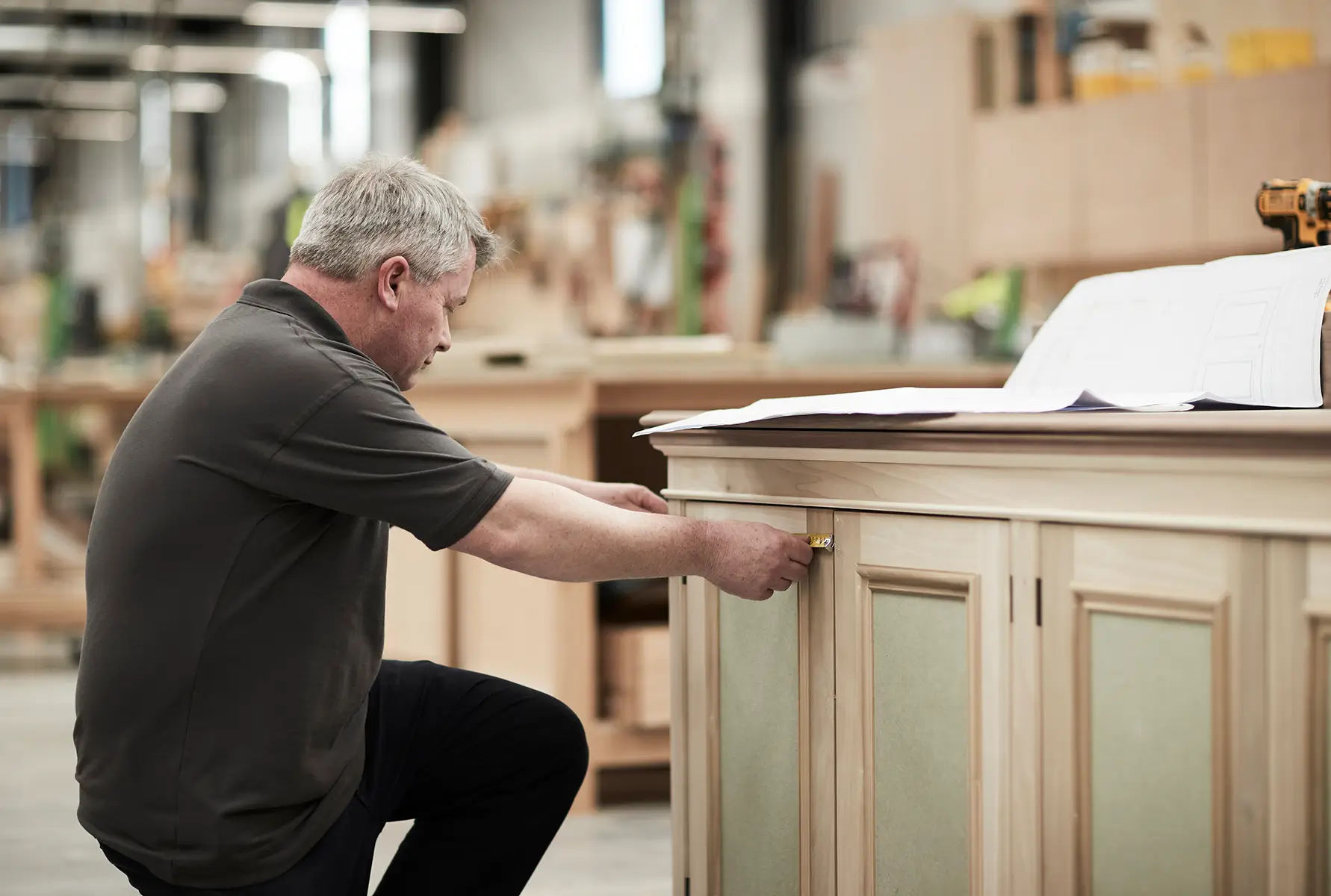 Person measuring a cabinet image