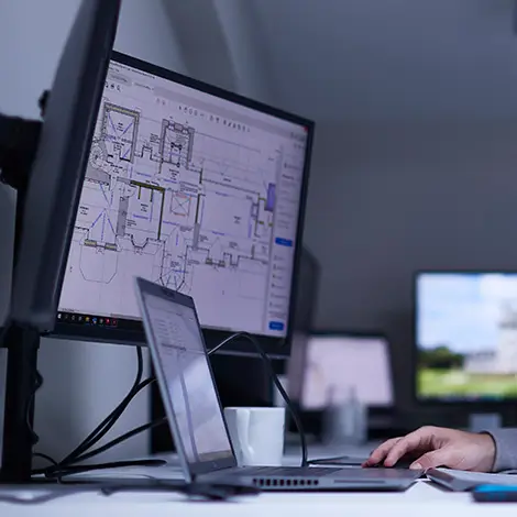 Close up of person at a screen showing CAD drawings