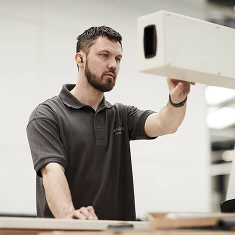 Joiner working at a woodworking machine