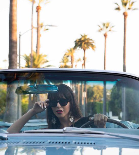 Woman driving convertible