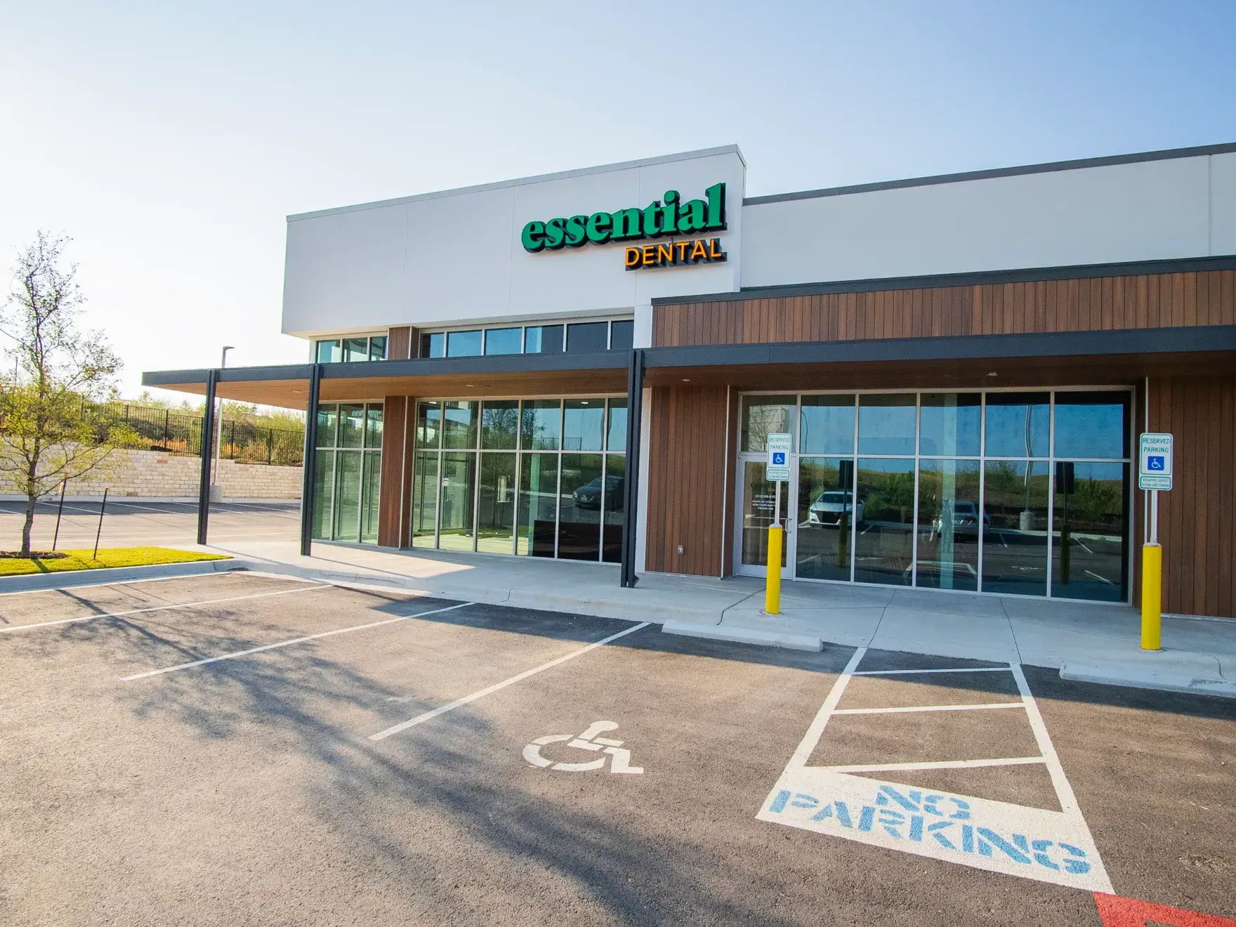 Front view of a dental office with large windows and a visible entrance.