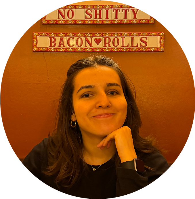 a woman smiling with her hand on her chin