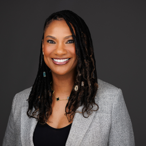 woman wearing a grey blazer and a black shirt