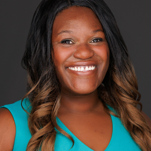 Jamison's headshot features her in a teal colored blouse and a smile.