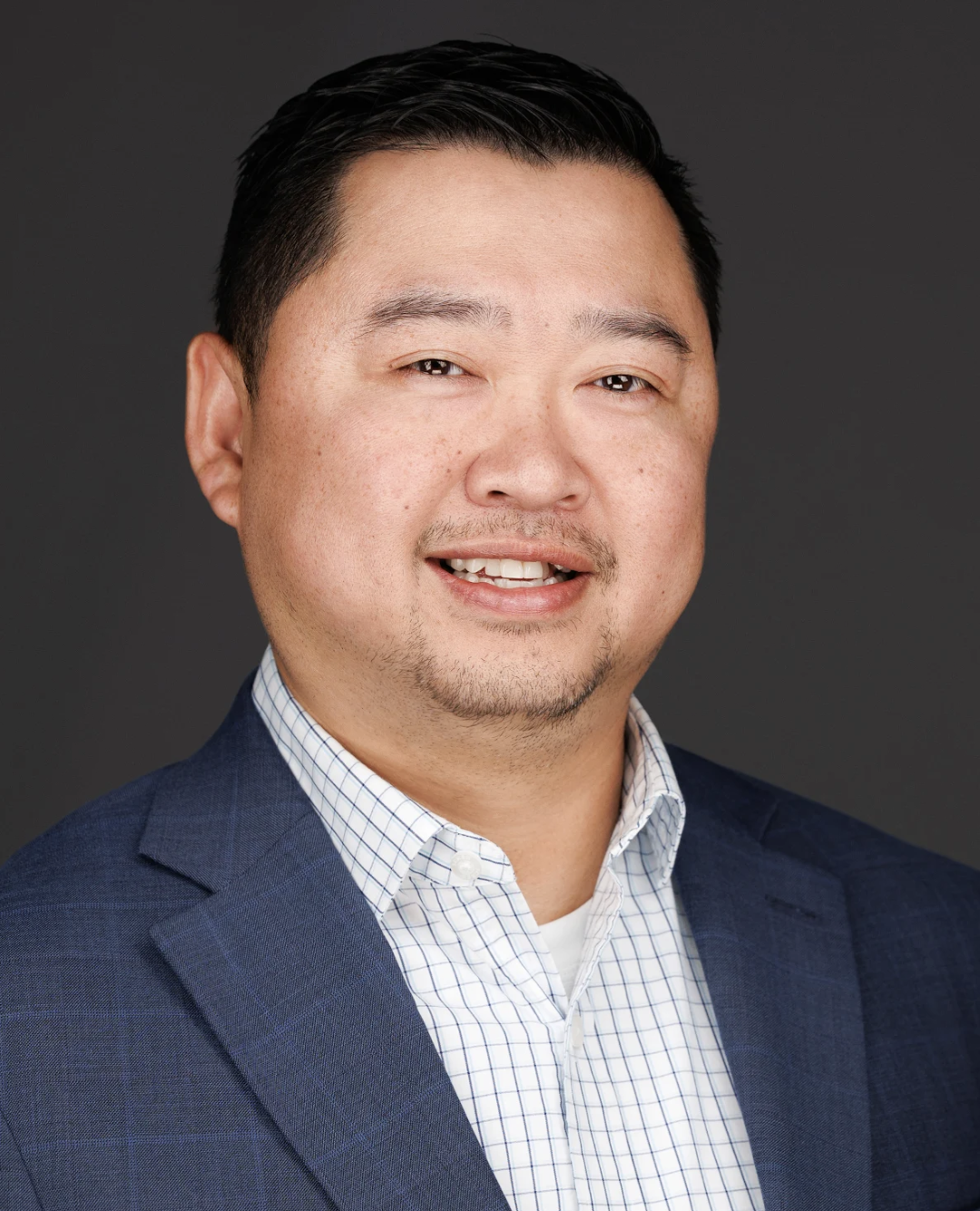Man wearing blue suit blazer and button up shirt.