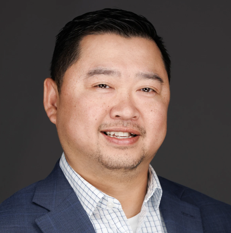 Man wearing blue suit blazer and button up shirt.