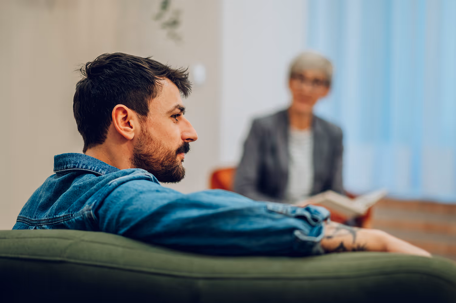 man sitting talking to woman