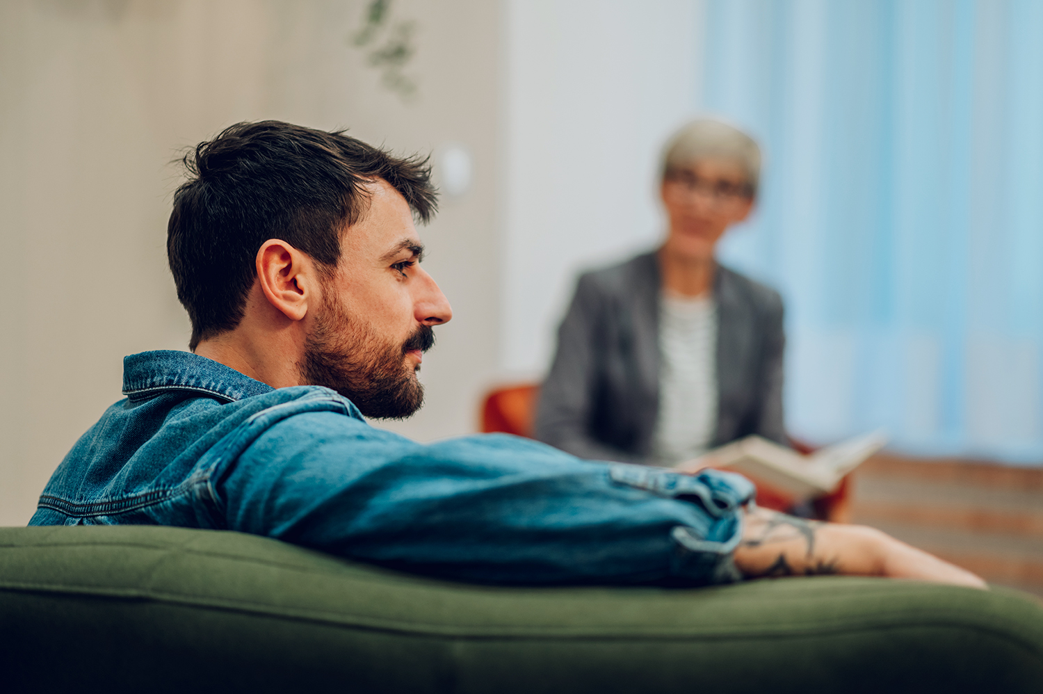 man sitting talking to woman