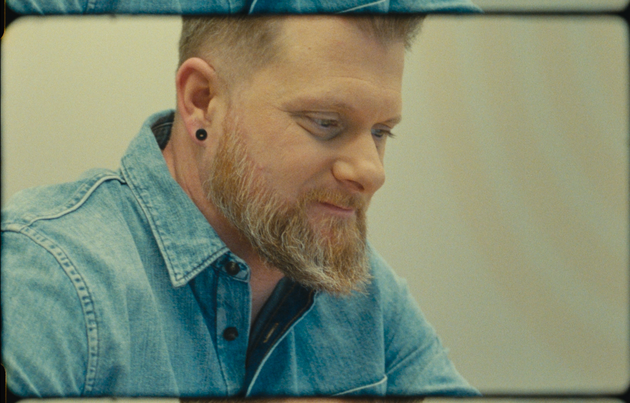 A warm, grainy 16mm film still of a customer featured in the HubSpot 'Spotlight' campaign.