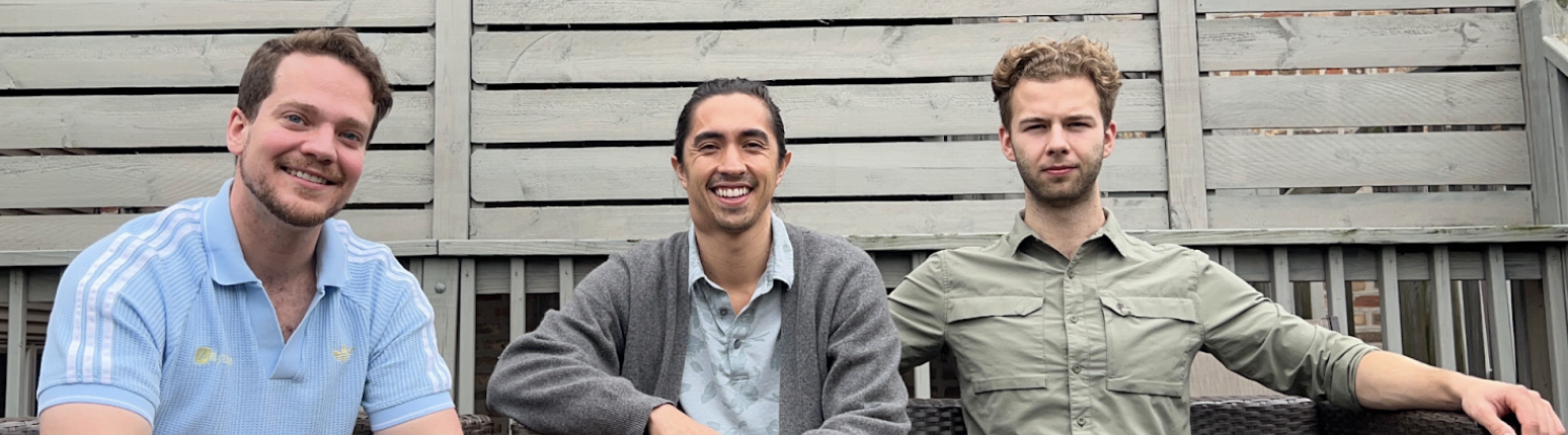 Three handsome men, confidently seated with likable smiles on their faces.