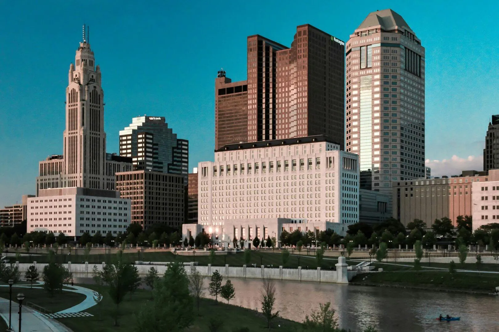 Downtown Columbus, Ohio skyline at sunset with high-rise buildings and a riverfront park — representing Sell2Rent’s leaseback services available in Ohio.