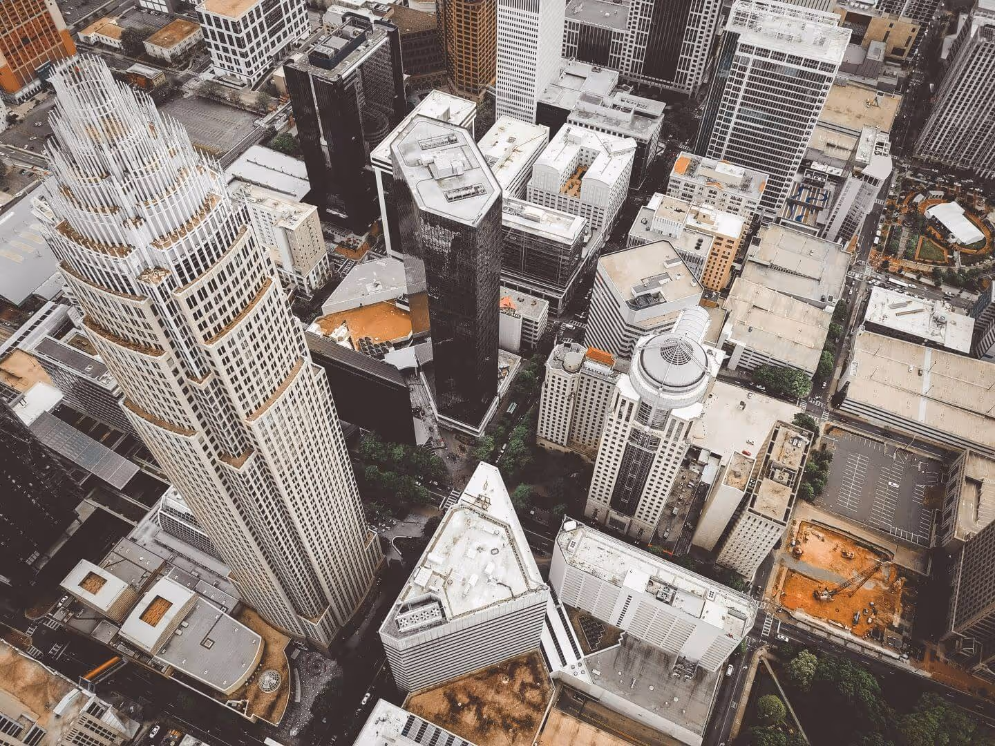 Aerial view of uptown Charlotte, North Carolina showcasing tall skyscrapers and urban development — highlighting Sell2Rent’s leaseback services available across the state.
