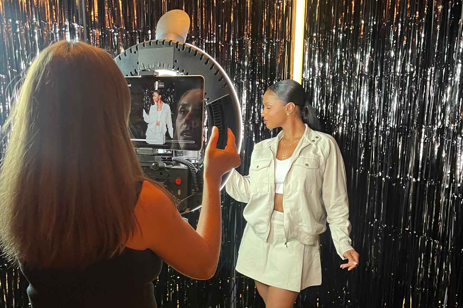 Teen guest creating fun music video in interactive video booth at Bar Mitzvah celebration in Miami