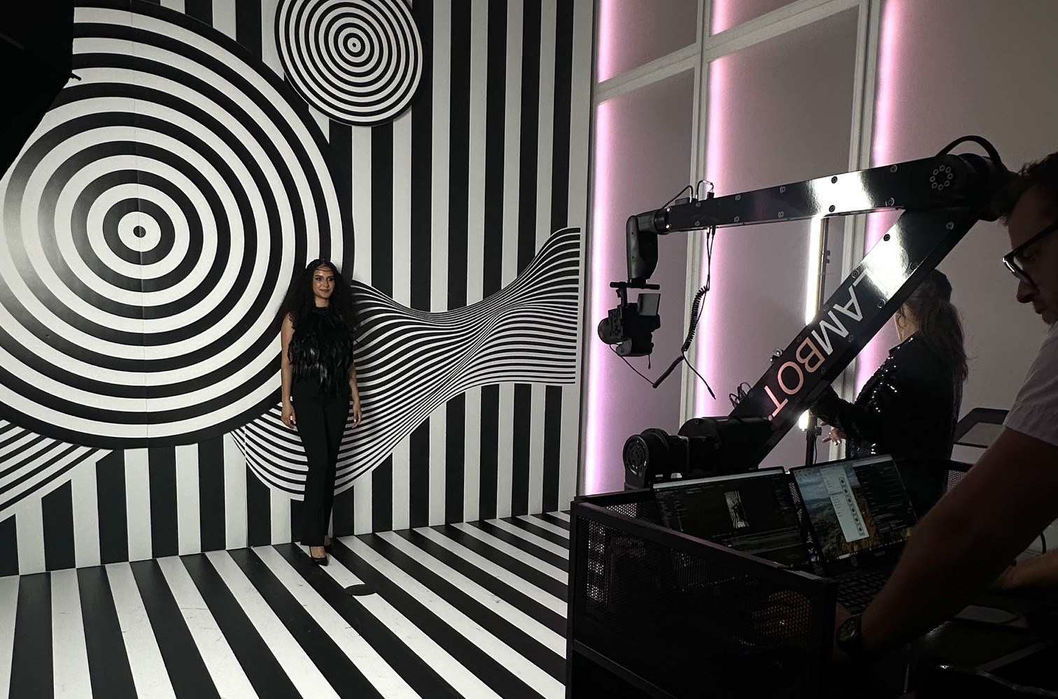Behind the scenes of a Glambot rental in Miami, the robotic camera arm and black-and-white striped set