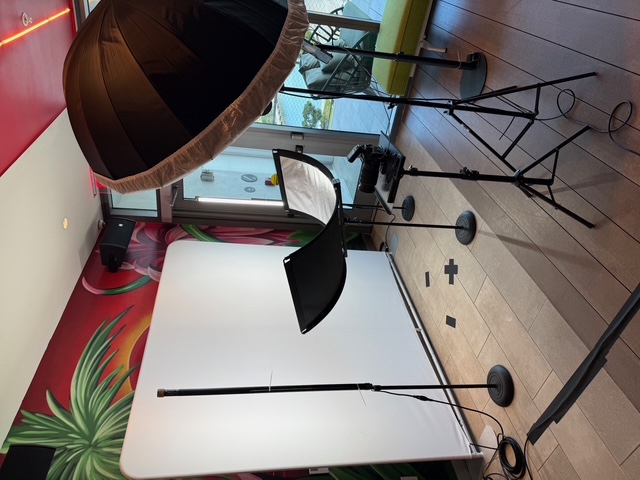 Behind-the-scenes corporate headshot studio setup with white backdrop and softbox lighting