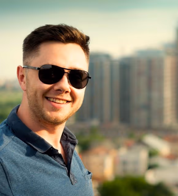 Real estate agent smiling with Calgary AB skyline in background