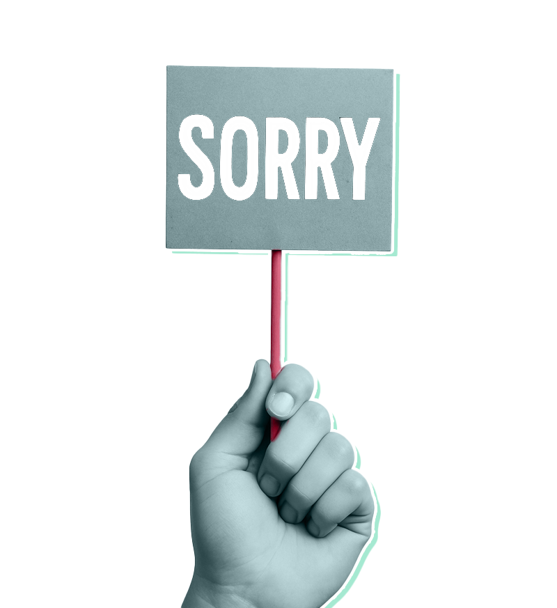 A hand holding up a sign that says 'sorry'