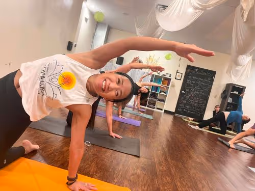 Woman doing side plank at a yoga studio