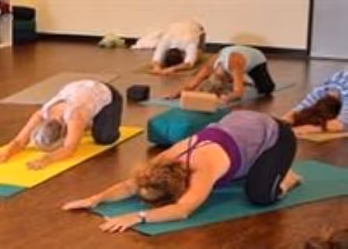 Yoga class doing child's pose