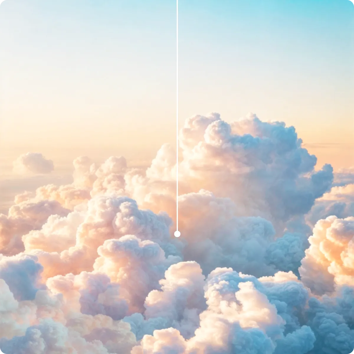 Fluffy clouds glowing with pink and blue hues under a soft, gradient sky at sunrise or sunset.