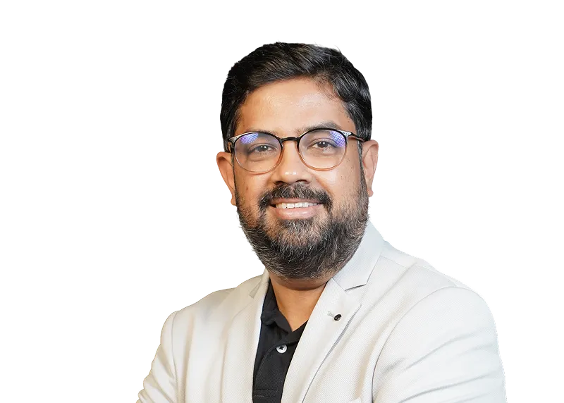 Smiling man with glasses, beard, and mustache wearing a light blazer over a black shirt.