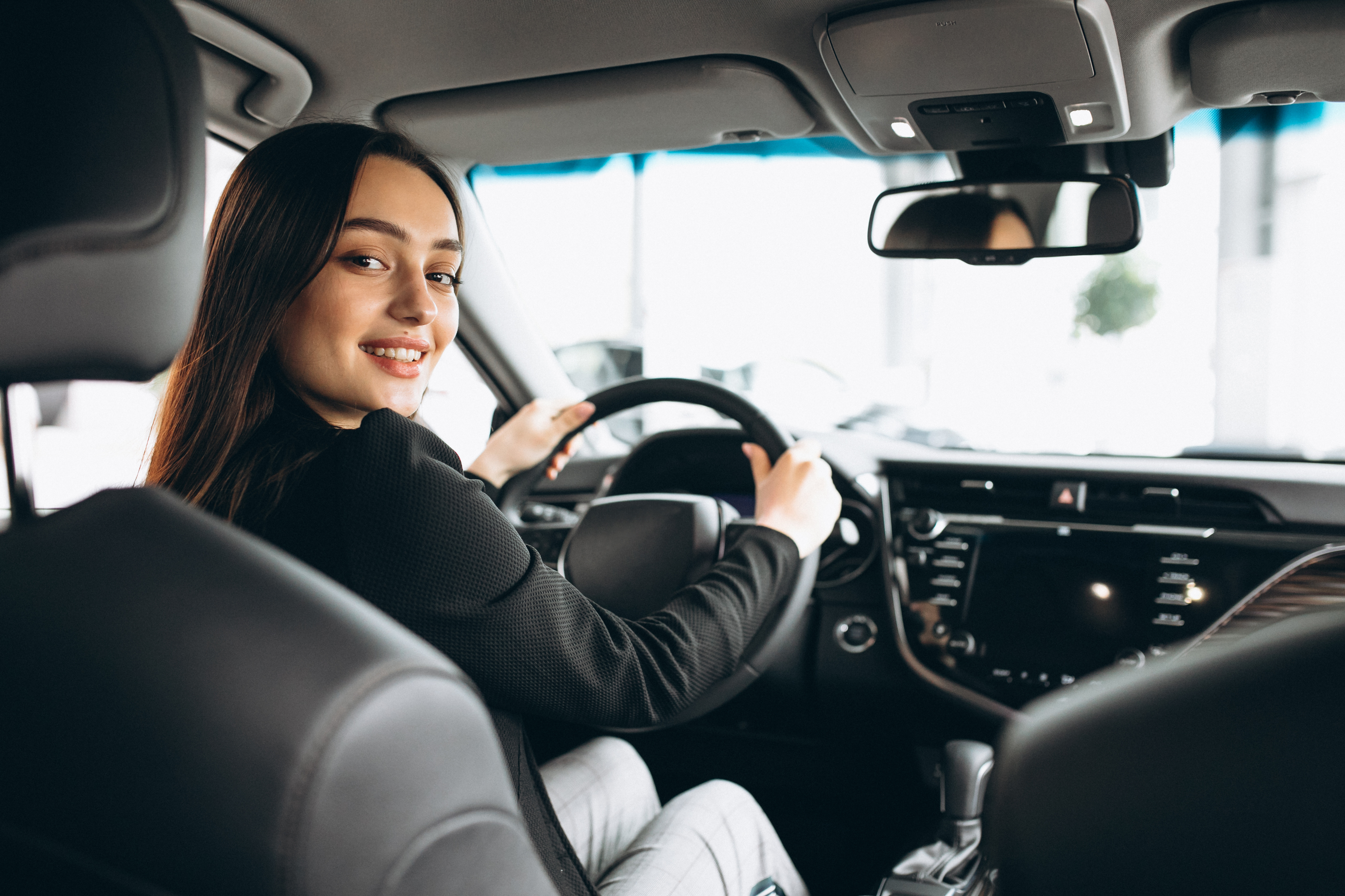 young-woman-testing-car-car-showroom