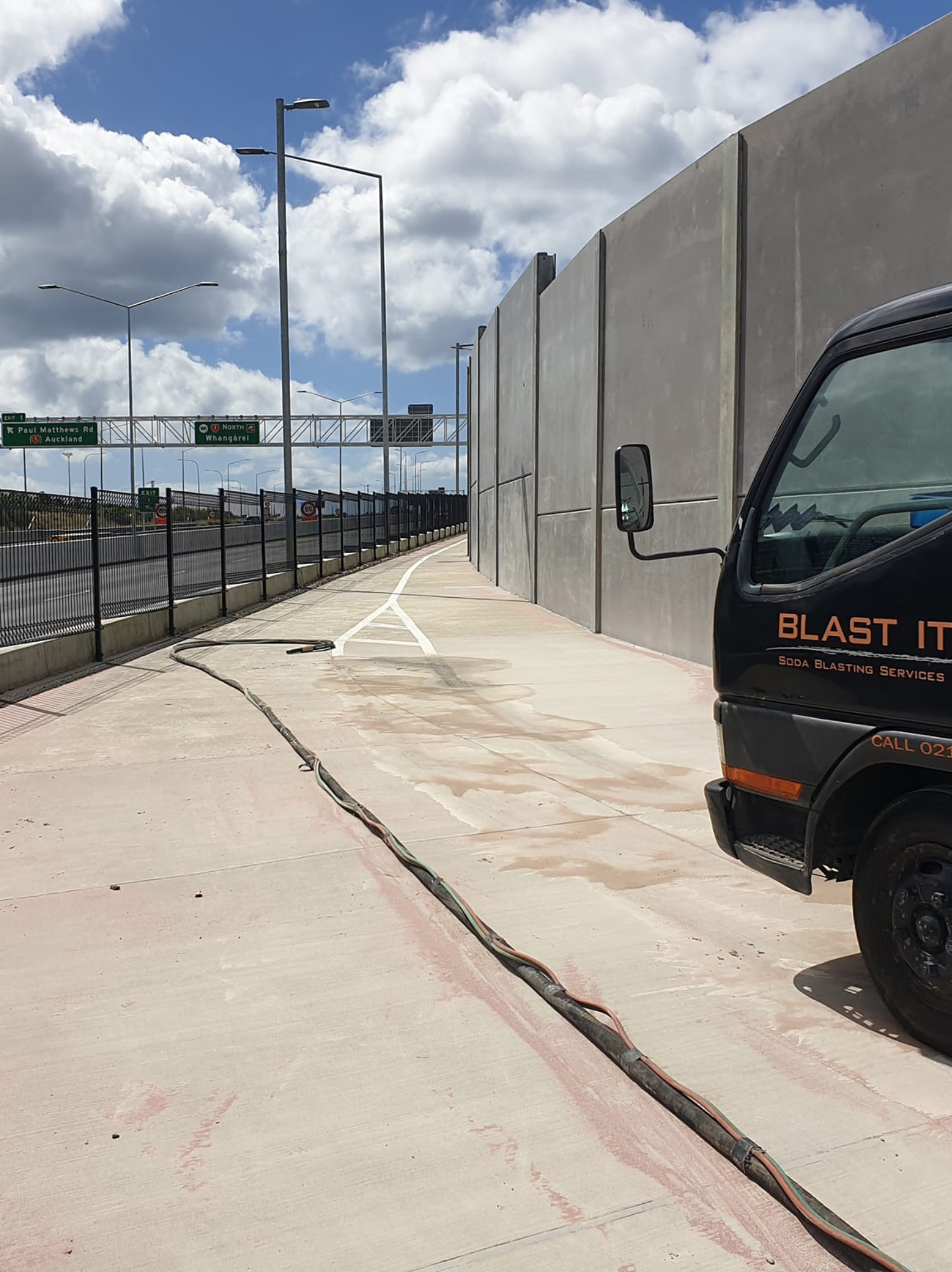 Commercial graffiti and surface cleaning project beside concrete wall