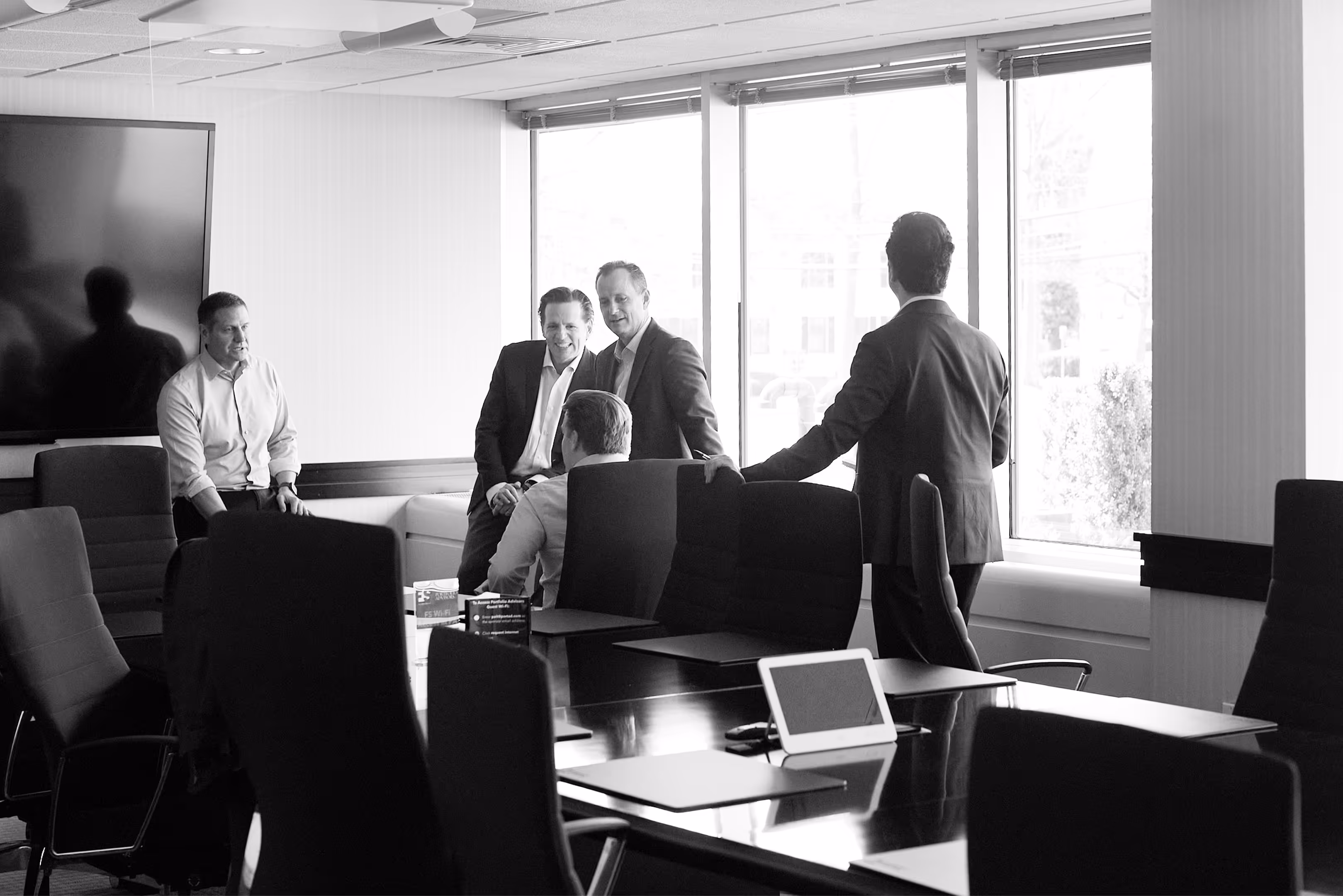 Five men meeting in a conference room