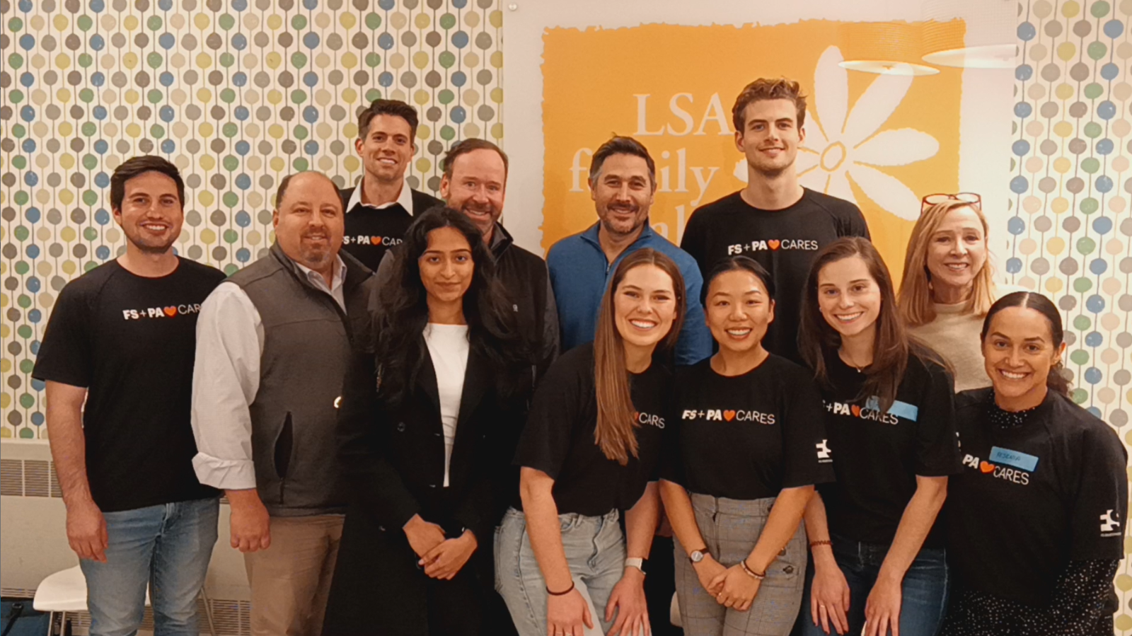 Group photo of volunteers in front of an LSA poster.