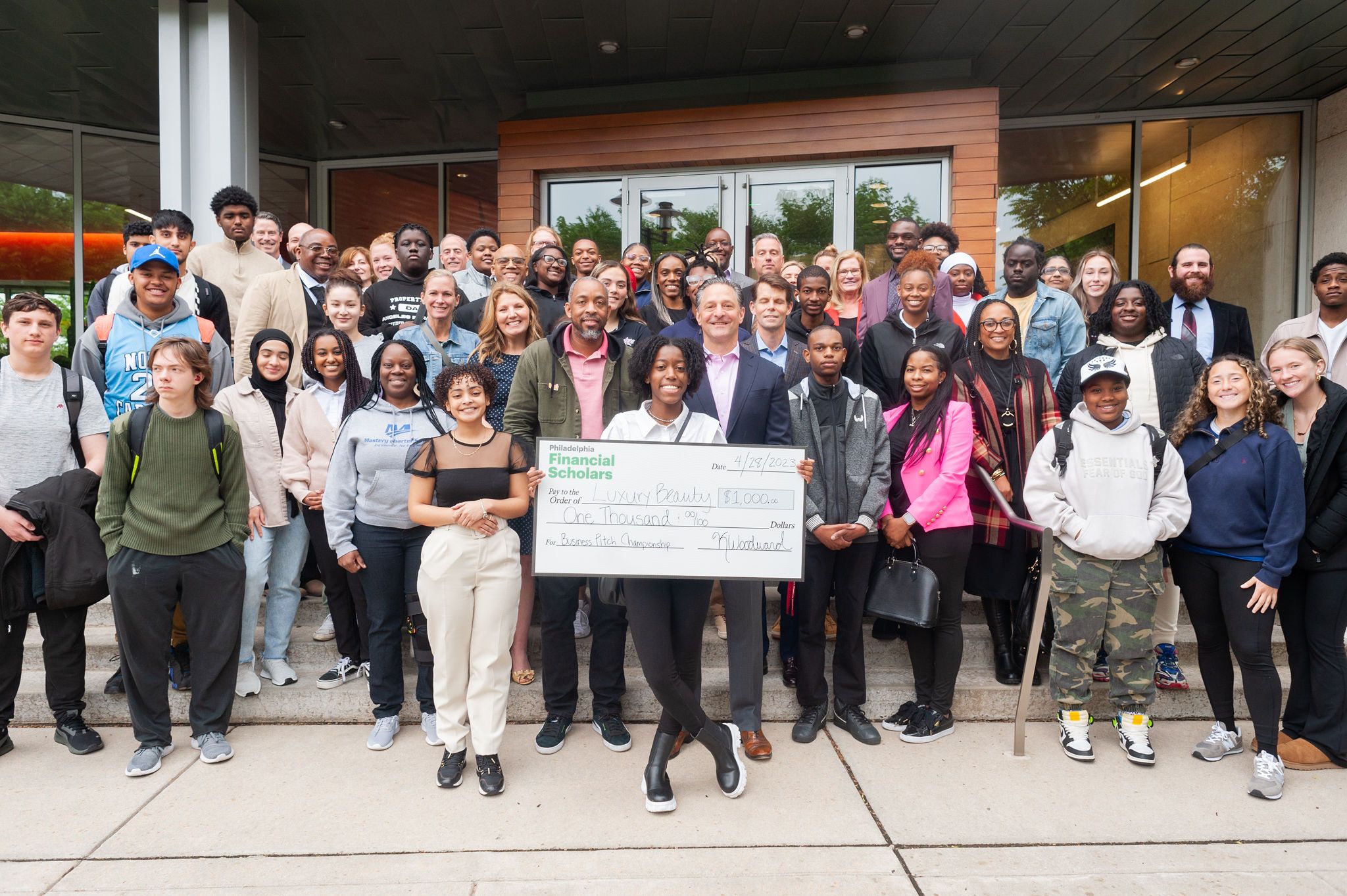 Group photo of students and FS employees, with one person holding a large $1000 check for the competition win.