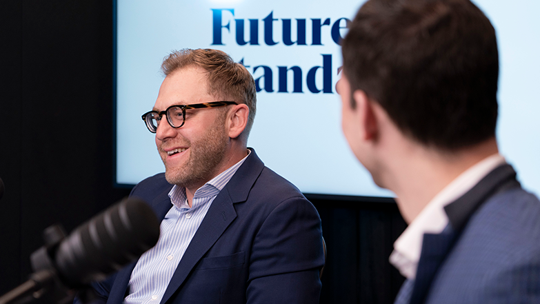 Scott Burr speaking during a podcast recording with host Alan Flannigan in the foreground.