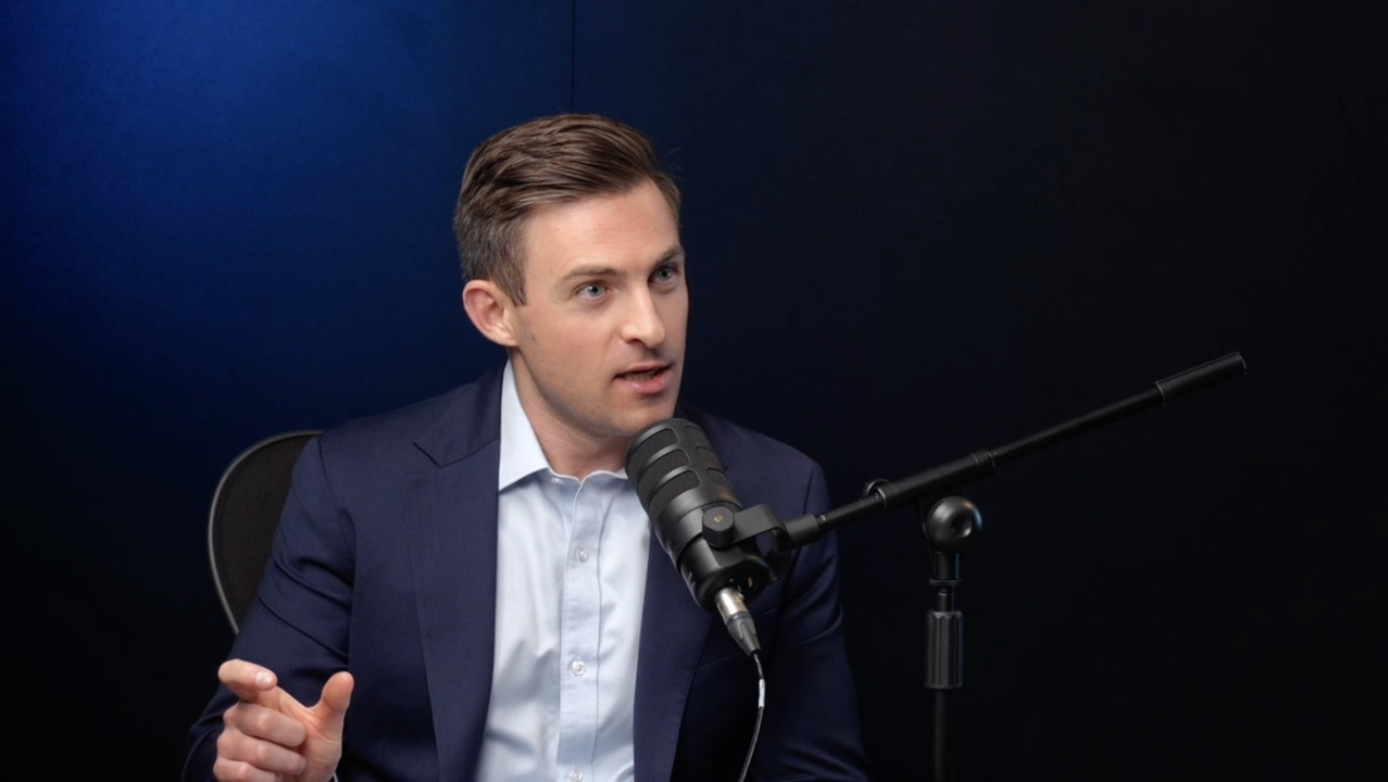 Andrew Korz speaking into a microphone during a podcast recording.