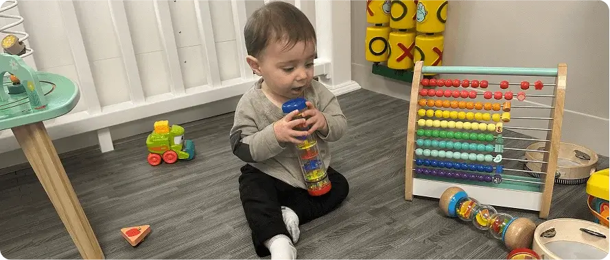 An image of a toddler playing with a stacking toy