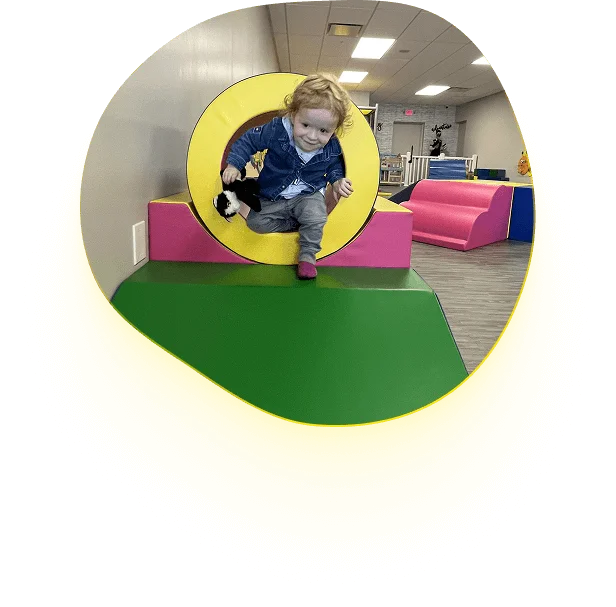 An image of  a child exploring a safe and colorful soft play area

