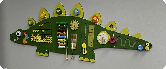 An image of  a sensory play wall in the shape of an dinosaur.