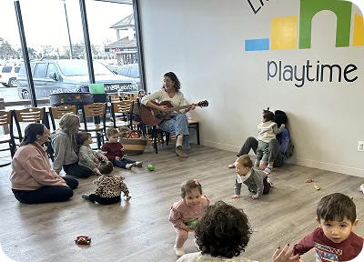 An image of parents and kids enjoying a relaxed space with music and toys.