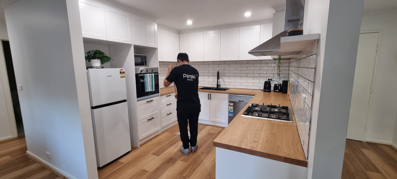 A Perski employee cleaning a kitchen.