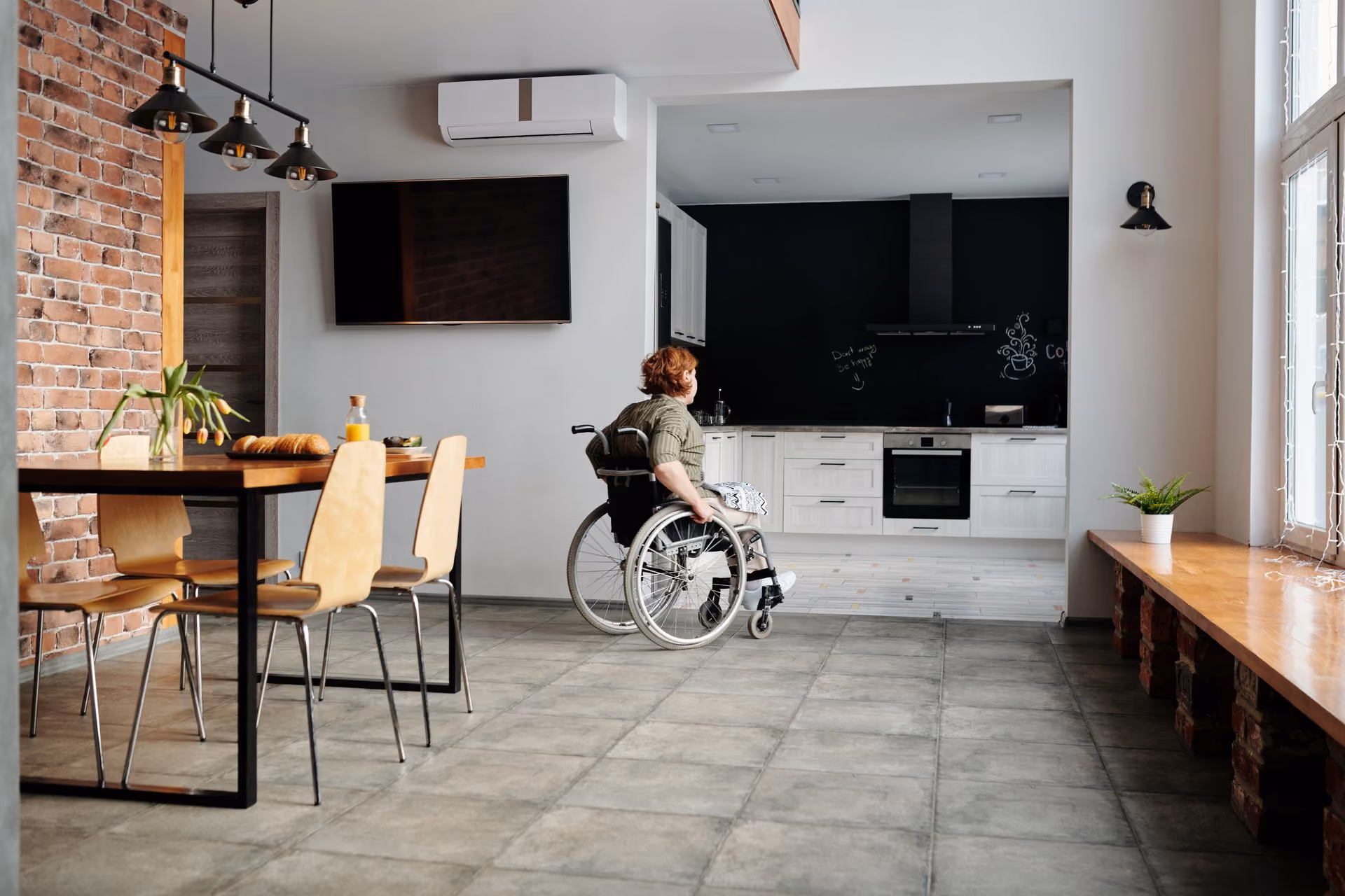 A NDIS participant strolls through their clean living space which provides them with independence and comfort.