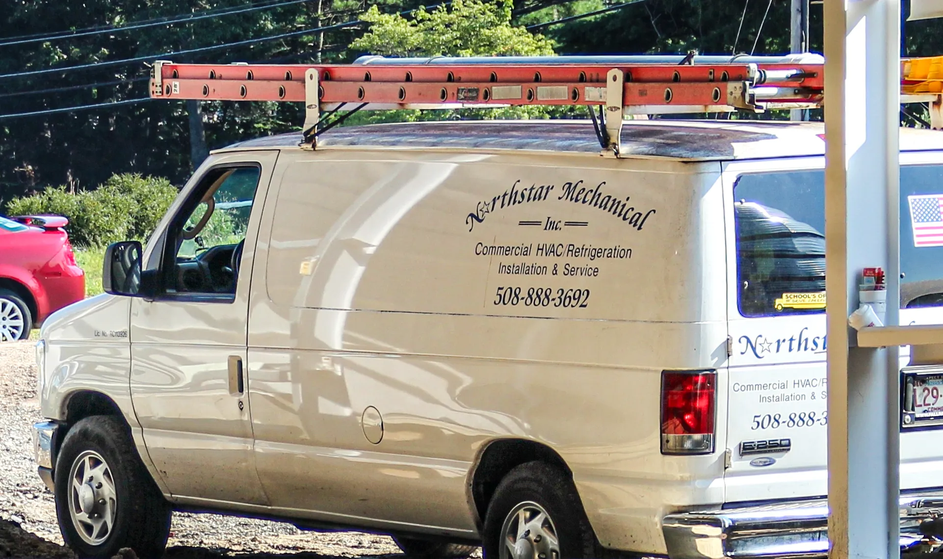 White Northstar Mechanical service van with roof ladder and business contact information displayed on the side.