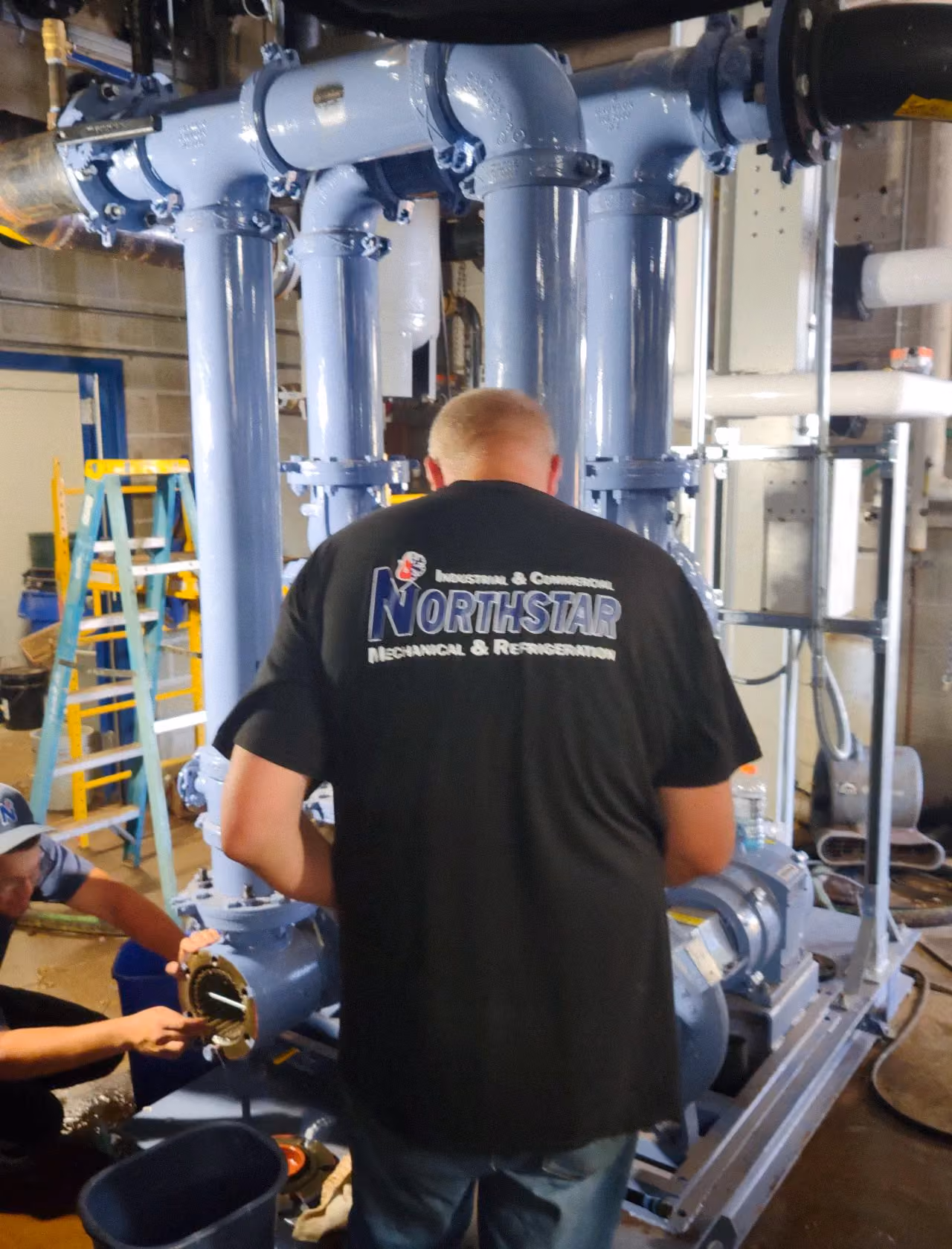 Northstar Refrigeration technicians servicing industrial refrigeration piping in a mechanical room — Plymouth MA HVACR contractor