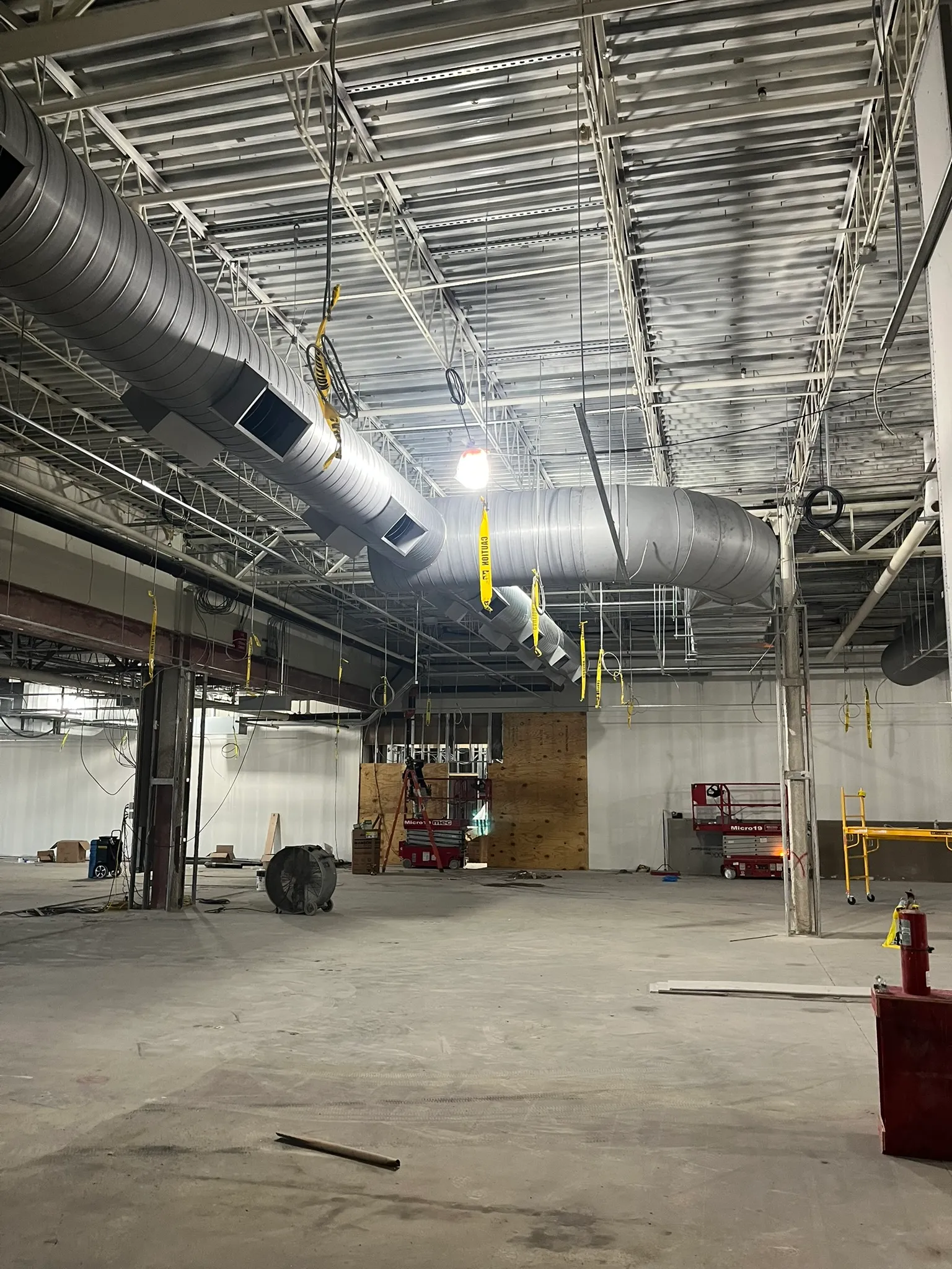 Spiral ductwork installation in a large industrial facility.