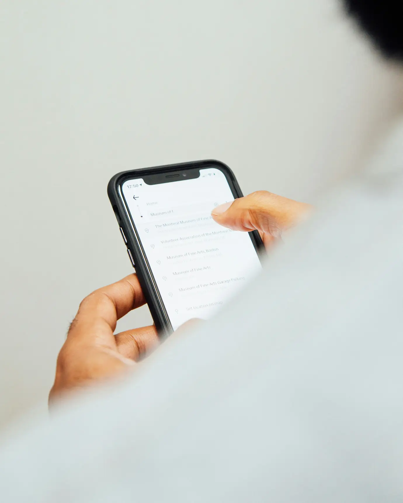 A person holding a cell phone in their hand.