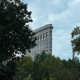 A very tall building sitting between some trees.