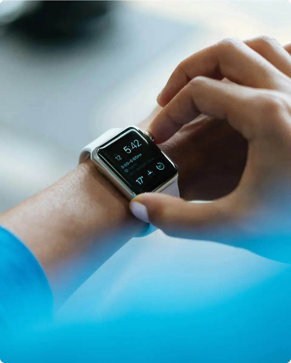 A person wearing a smart watch on their wrist.