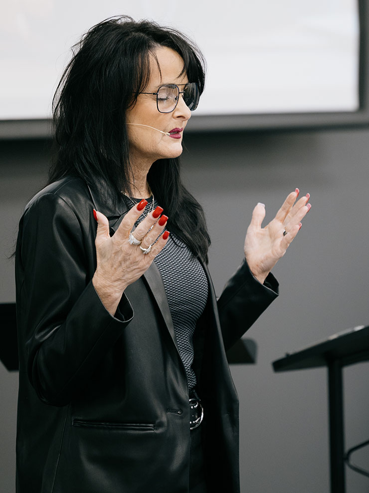 Dr. Karen Smith praying before class