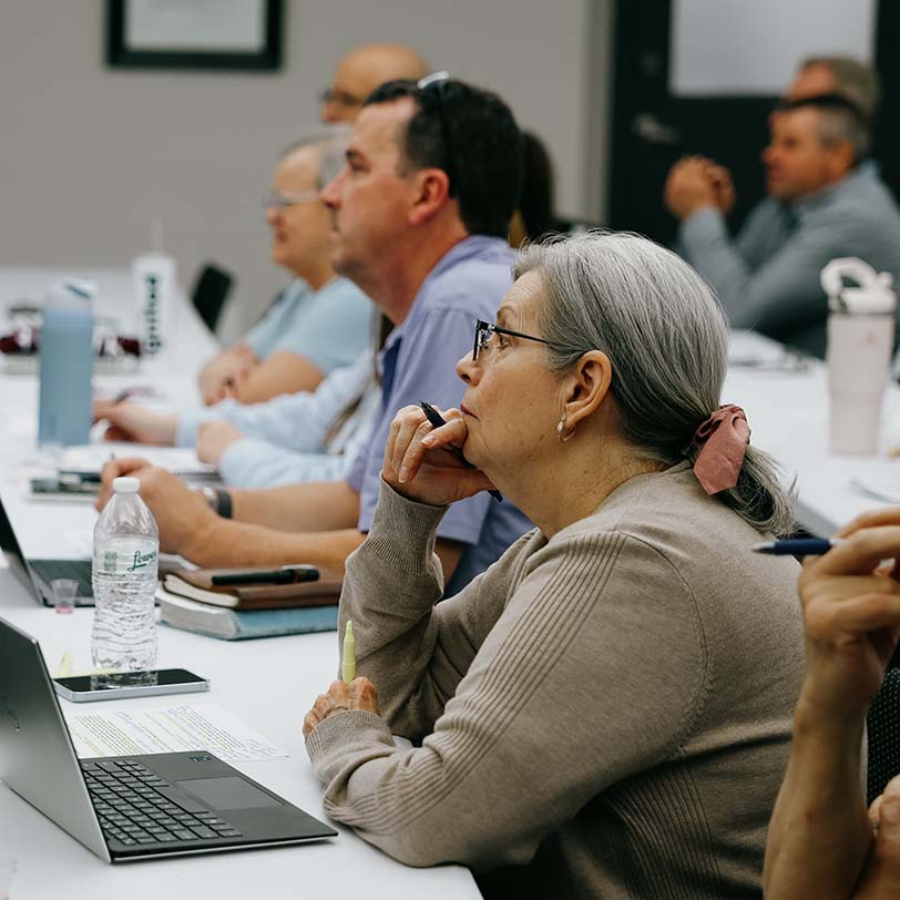 Woman sitting and paying attention during KINEO class