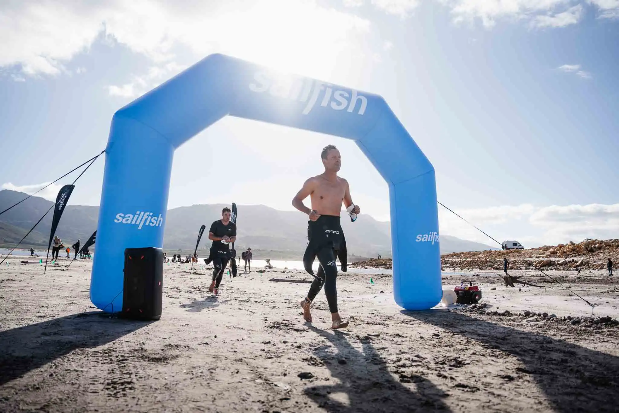 Athletes passing under the race arch at XTERRA South Africa — XTERRA event photographer Cape Town